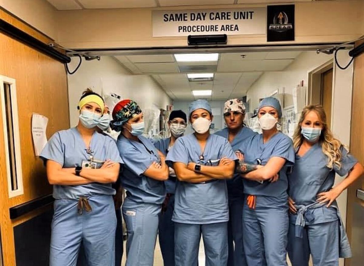 Mission Hospital ICU nurse Tiffany Hughes with colleagues at the Mission Viejo facility's COVID-19 unit.