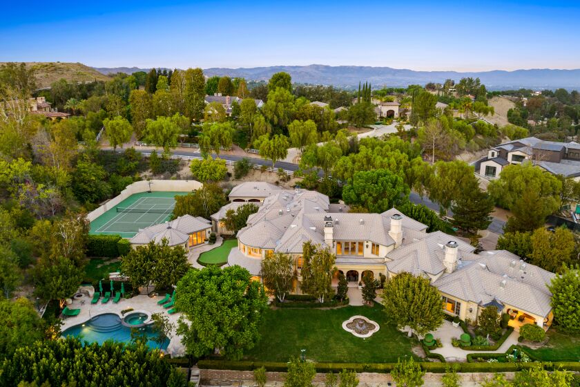 The two-acre spread includes an 11,000-square-foot mansion surrounded by a swimming pool, tennis court and putting green.