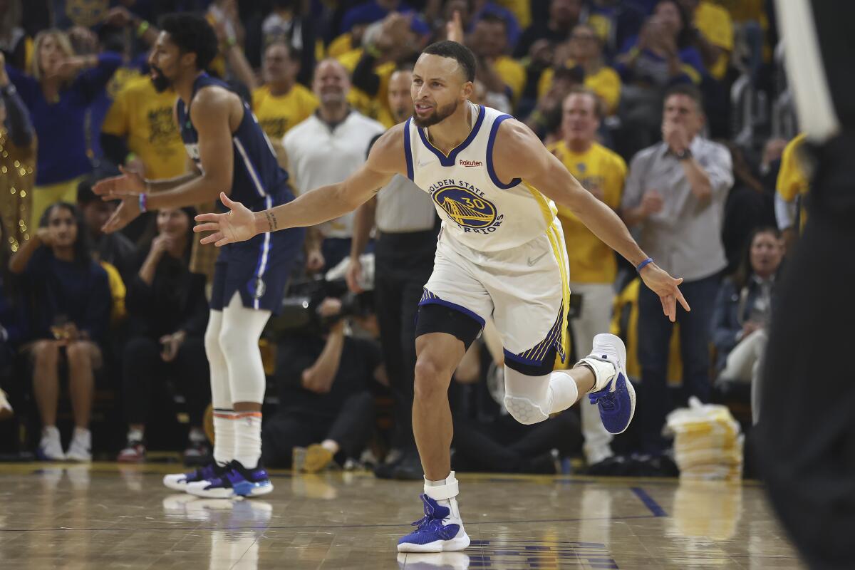 Golden State Warriors guard Stephen Curry reacts during the first half of a victory over the Dallas Mavericks.