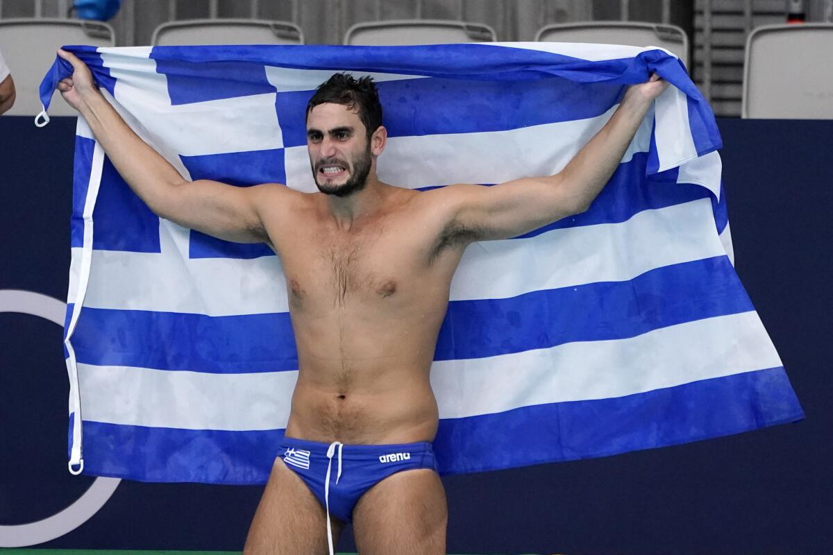 Greece's Marios Kapotsis celebrates after a win over Hungary in a semifinal round men's water polo match at the 2020 Summer Olympics, Friday, Aug. 6, 2021, in Tokyo, Japan. (AP Photo/Mark Humphrey)