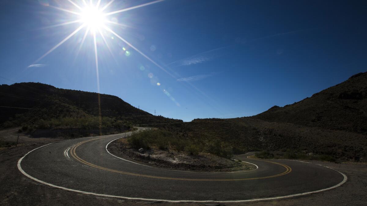 One of a pair of 10-mph hairpin turns on Oatman Highway. (Brian van der Brug / Los Angeles Times)