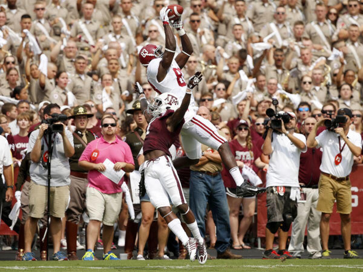 Alabama's Kevin Norwood makes a touchdown catch over Texas A&M;'s De'Vante Harris during Saturday's game in College Station, Texas.