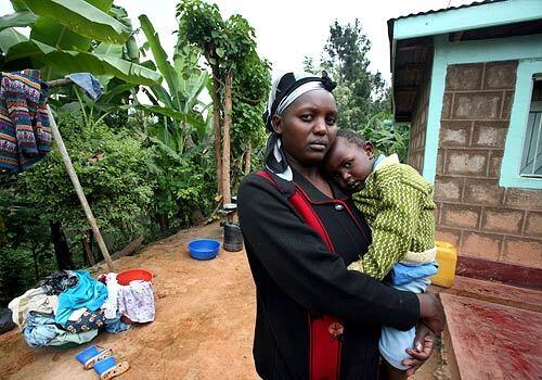 Charity Njuki holds her recently recovered son, Eric, outside their home in the village of Thangathi, in Kenya's central highlands. When I was growing up, we never heard of malaria, she said.