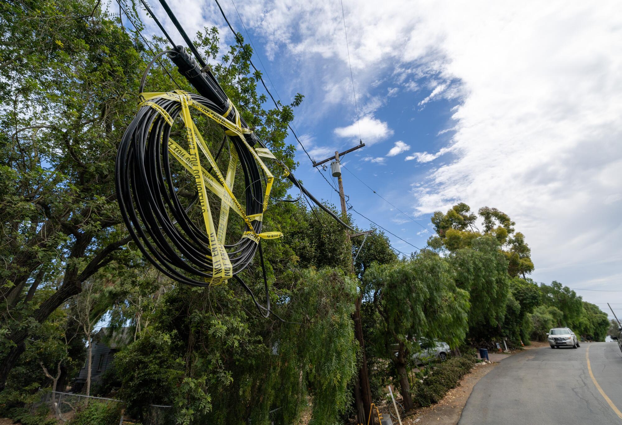 Power lines are marked with caution tape in the Portuguese Bend neighborhood