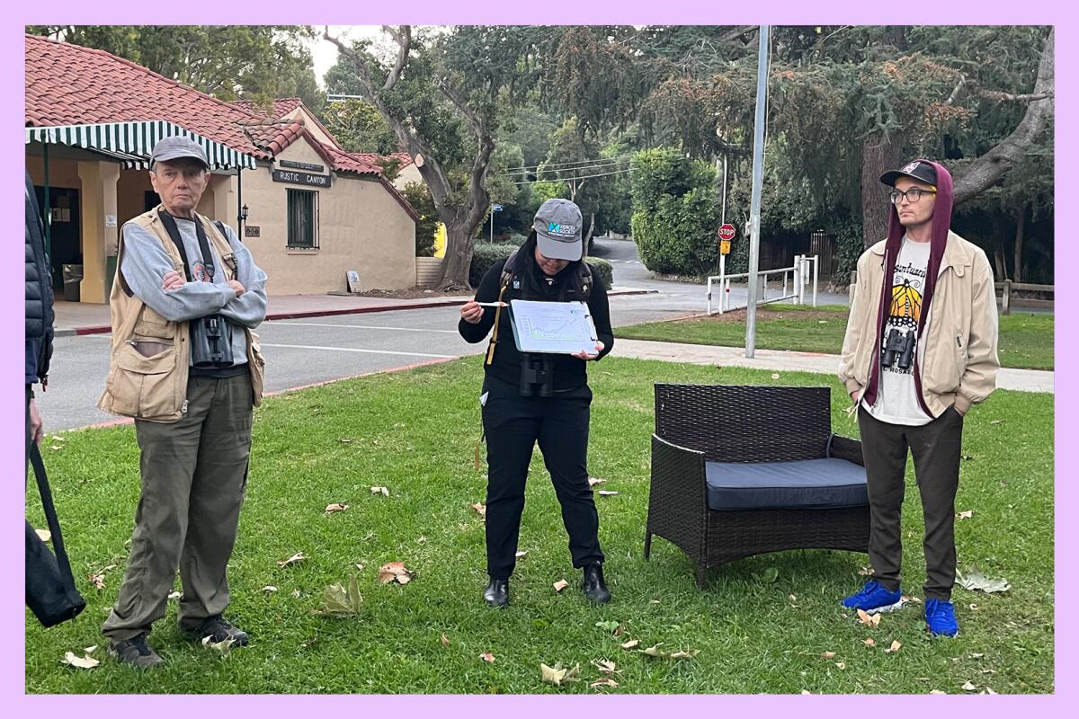 Three people standing in a park-like area