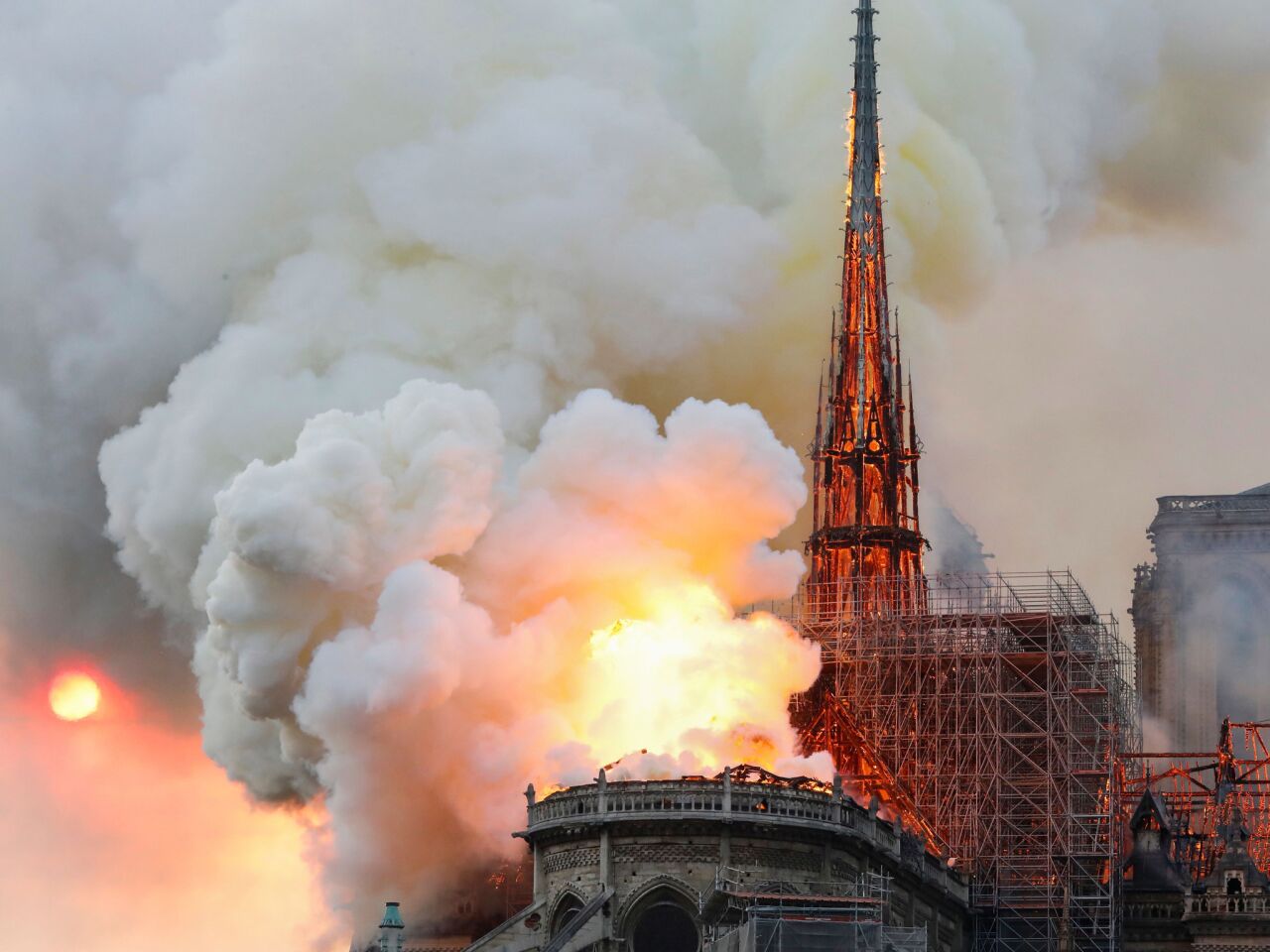 Smoke and flames rise from a fire at the landmark Notre Dame Cathedral in central Paris.