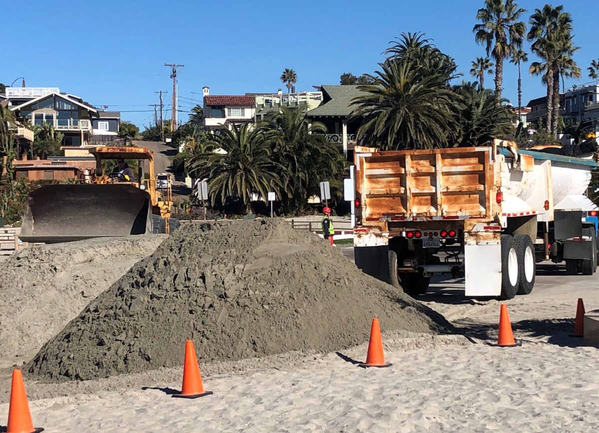 Crews began pouring sand on the beach at 7 a.m. on Feb. 6