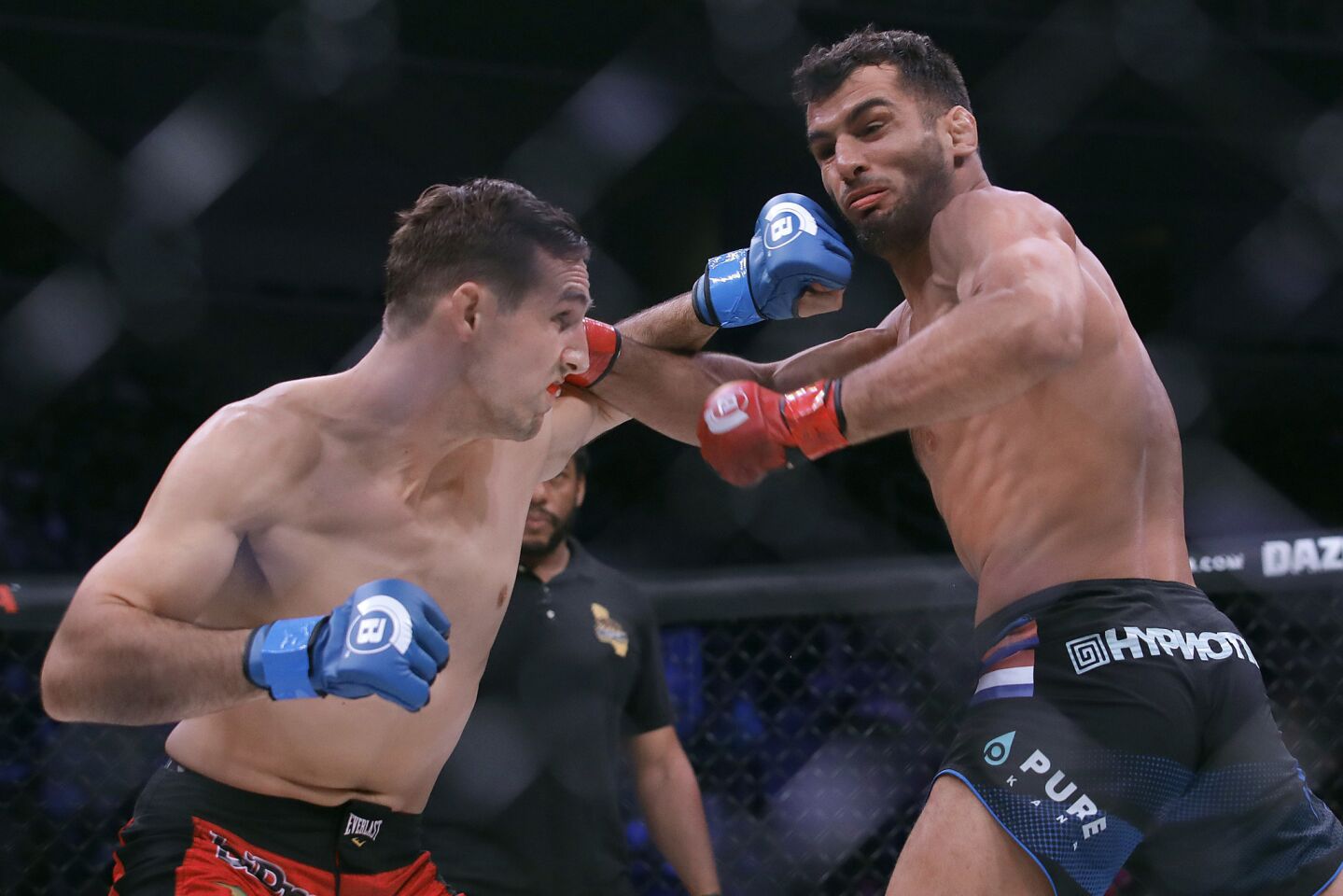 Rory MacDonald, left, trades punches with Gegard Mousasi during a middleweight world title mixed martial arts bout at Bellator 206 in San Jose, Calif., Saturday, Sept. 29, 2018. Mousasi won by technical knockout in the second round to retain the title. (AP Photo/Jeff Chiu)