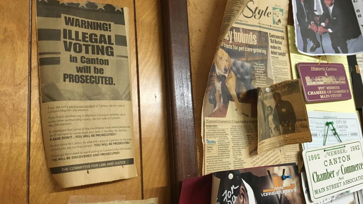 An old newspaper ad taped to the wall at the office of WMGO-AM 1370 in Canton, Miss., warns against illegal voting,