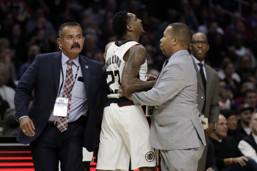 Los Angeles Clippers' Lou Williams, center, is held back after being ejected during the second half of the team's NBA basketball game against the Houston Rockets on Thursday, Dec. 19, 2019, in Los Angeles. (AP Photo/Marcio Jose Sanchez)
