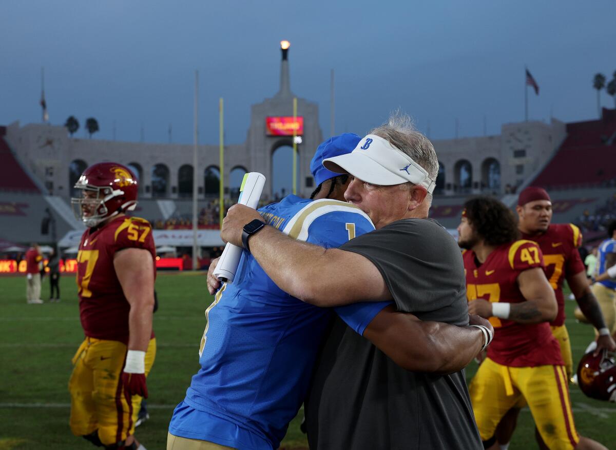 UCLA coach Chip Kelly hugs quarterback Dorian Thompson-Robinson after a 62-33 win over USC at the Coliseum.