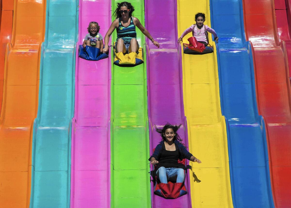 Orange County Fair visitors going down a giant slide seemed happy to welcome the fair’s 2014 theme, “Summer Starts Here.”