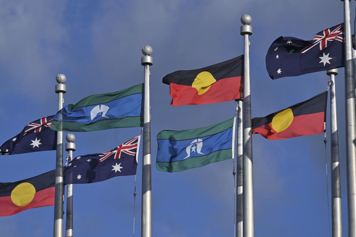 The Australian flag, the Indigenous flag and the flag of the Torres Strait Islands fly outside Parliament House in Canberra