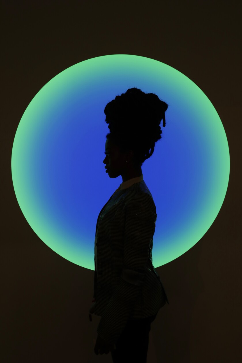 Fashion designer Amiraa Vee in front of work by James Turrell.