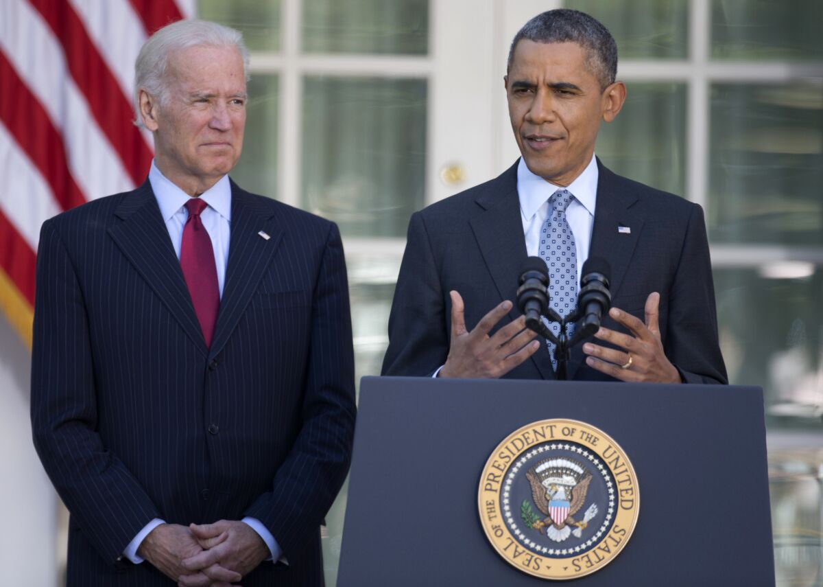 President Obama, with Vice President Joe Biden, speaks to reporters in the Rose Garden of the White House on Tuesday. The president said more than 7 million people signed up under the Affordable Care Act for healthcare insurance.