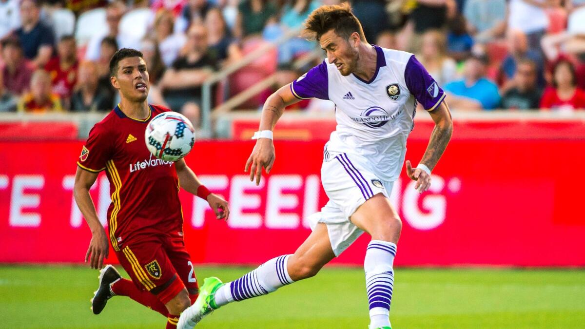 Orlando City's Jose Aja, right, and Real Salt Lake's Luis Silva go for the ball during a Major League Soccer match in Sandy, Utah, on June 30.