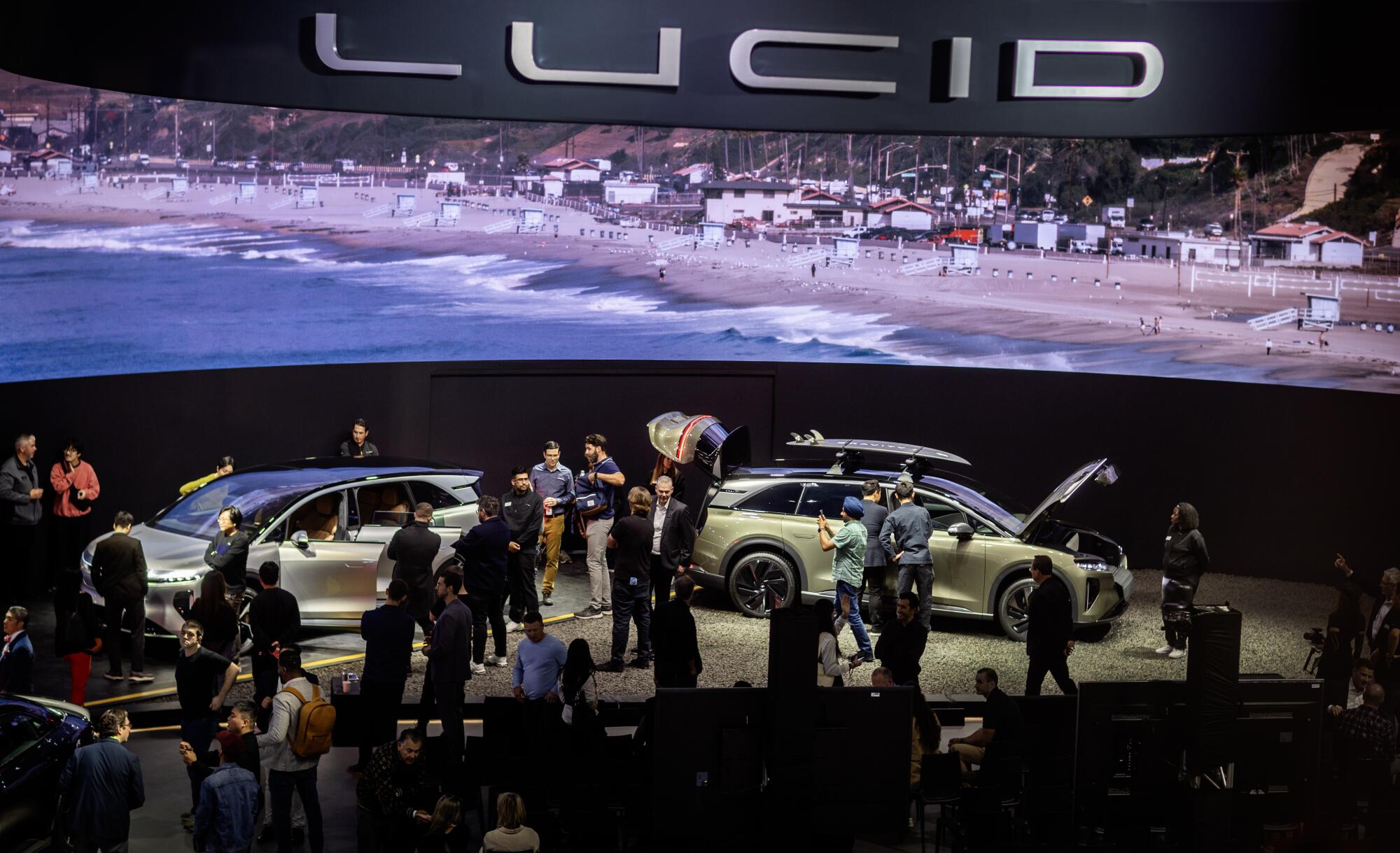 A crowd checks out the debut of the Lucid Gravity at the LA Auto Show.