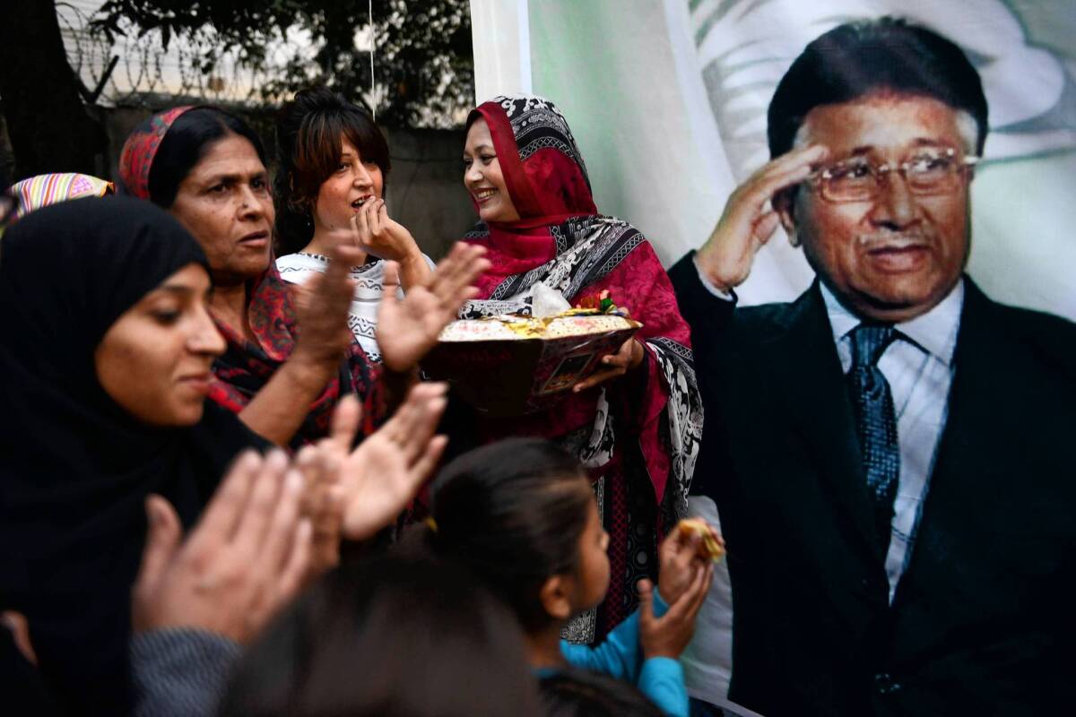 Supporters of former Pakistani President Pervez Musharraf, in poster, celebrate at a gathering in Islamabad after a court decision to grant him bail.