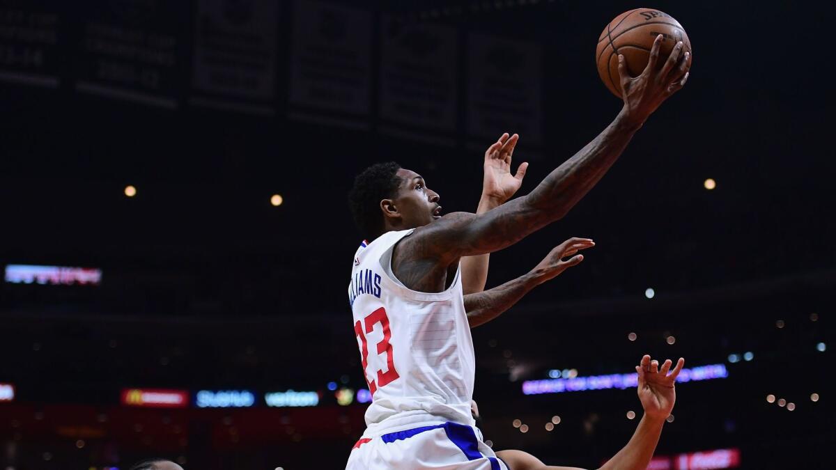 Clippers' Lou Williams scores past the Minnesota Timberwolves during a 126-118 Timberwolves win at Staples Center on Monday.