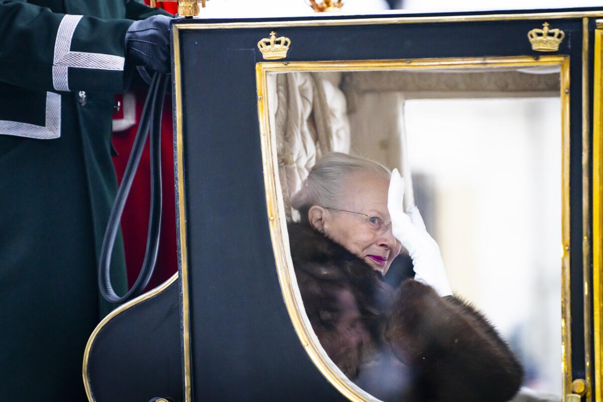 Denmark's Queen Margrethe inside a horse-drawn coach