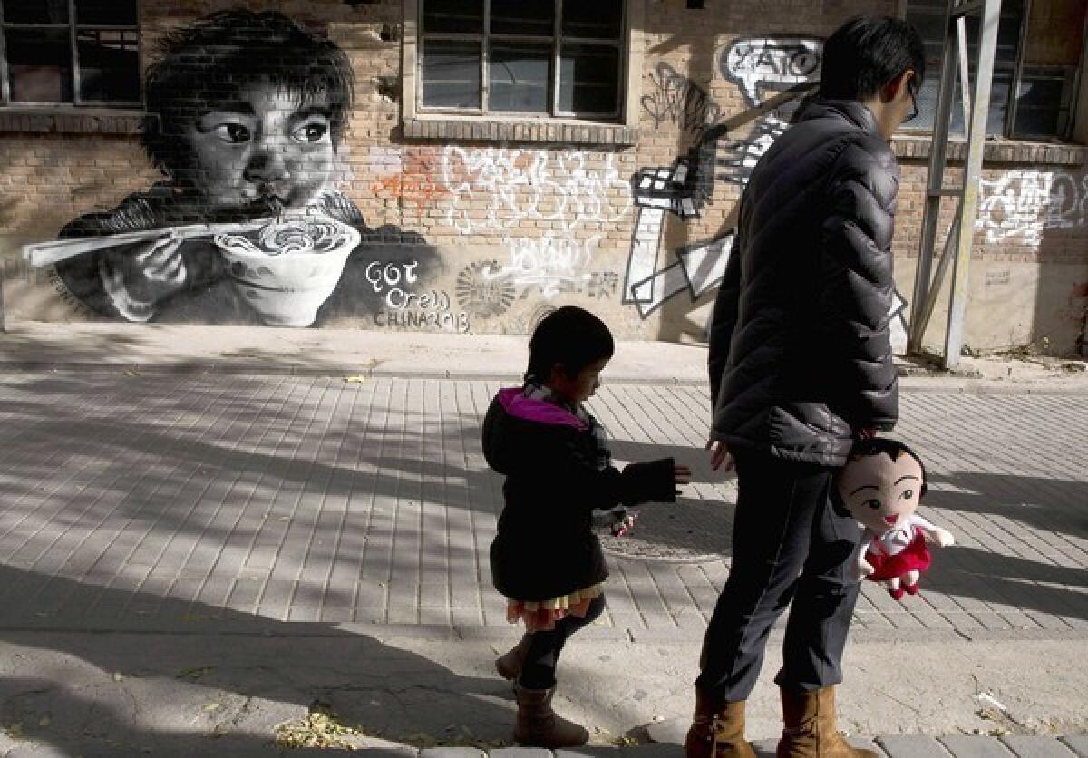 A woman and a child in Beijing. The Chinese government announced last week that it would ease the one-child policy to allow couples in which either partner is an only child to have a second baby.