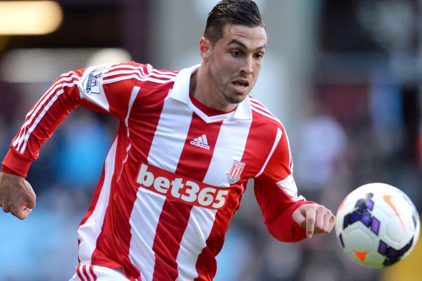 Stoke City defender Geoff Cameron chases down the ball during an English Premier League game against Aston Villa.
