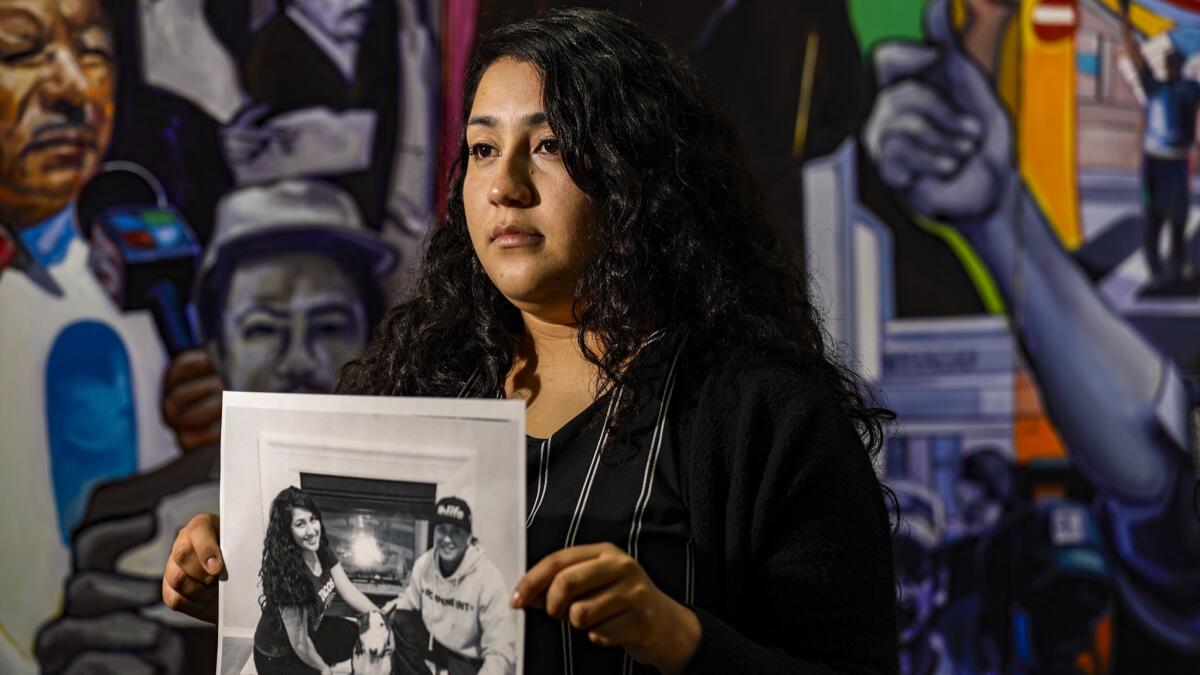 Melissa Castro holds a photo of her husband, José Ibarra Bucio, who had been held at the Adelanto detention center and died weeks after he was taken to a local hospital.
