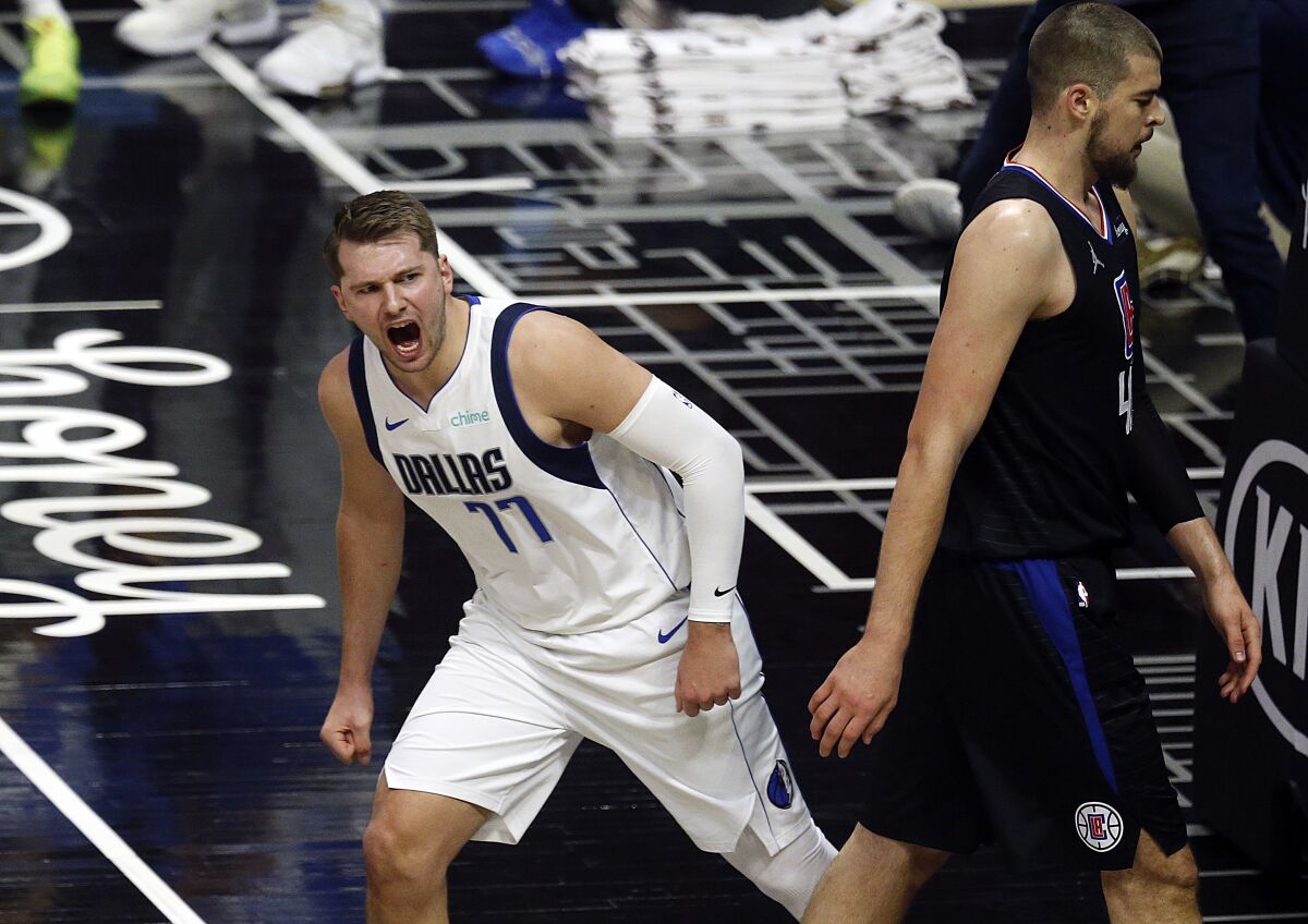 Mavericks guard Luka Doncic reacts after dunking against Clippers center Ivica Zubac.