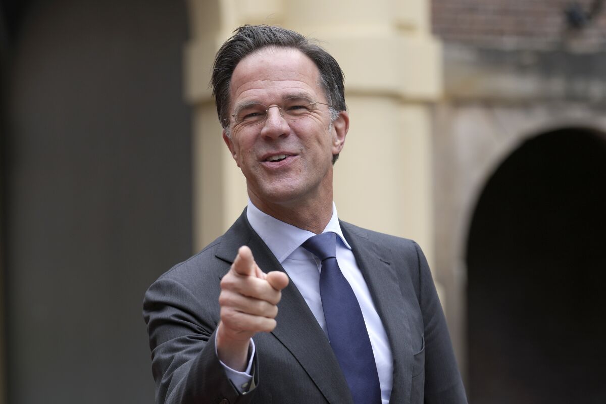 FILE - Dutch Prime Minister Mark Rutte points when joking with the media while waiting for the arrival of India's President Ram Nath Kovind in The Hague, Netherlands, Wednesday, April 6, 2022. Mark Rutte became the longest-serving Dutch prime minister Tuesday, Aug. 2, 2022 and the leader known by some as “Teflon Mark” because scandals don't stick to him is showing no sign of slowing despite unrest gripping his nation and his party's popularity sliding in polls. (AP Photo/Peter Dejong, File)