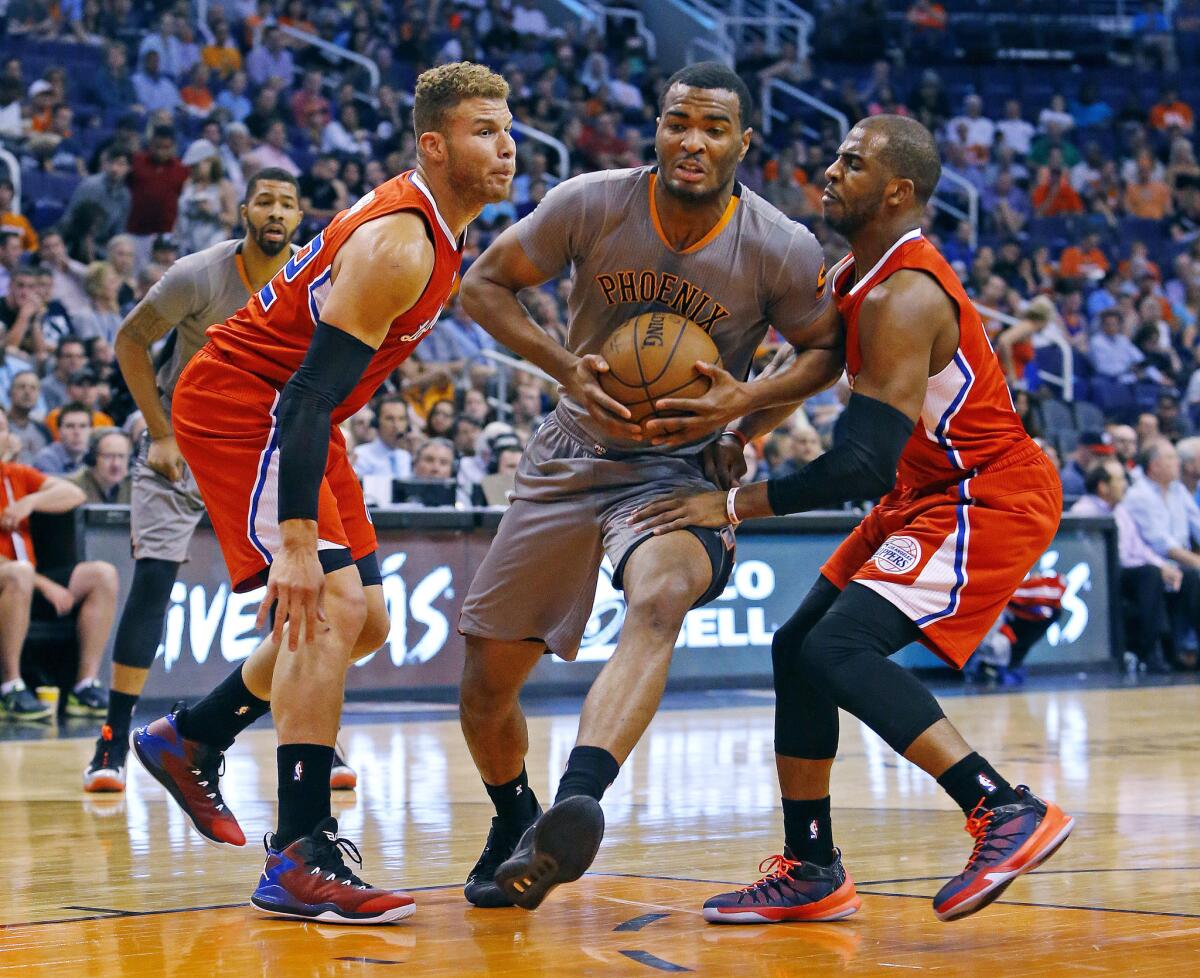 Phoenix forward T.J. Warren tries to split the defense of Blake Griffin and Chris Paul during the first half of the Clippers' 112-101 victory over the Suns.