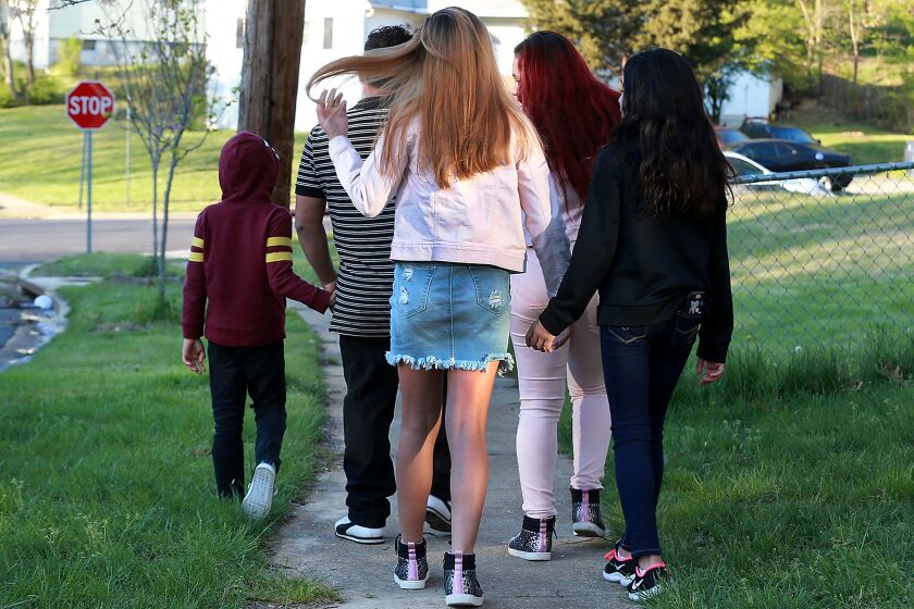 MD., APRIL 16, 2020: Jose C. and his kids, who were just released after being stuck for months in a government shelter, takes a rare walk to the corner amid shelter-in-place orders. (Kirk McKoy / Los Angles Times)