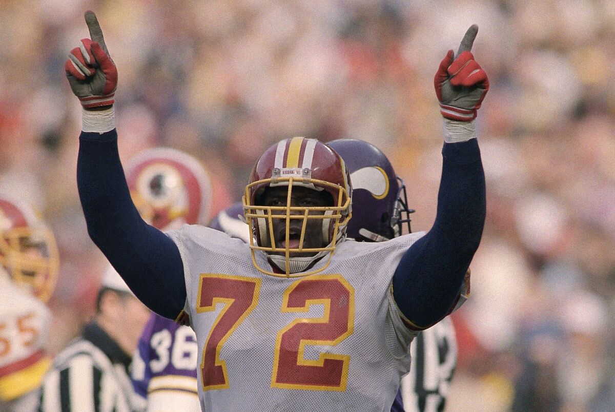 Washington Redskins right end, Dexter Manley (72), raises his arms giving the "No. 1" sign during Sunday's game against the Minnesota Vikings, clinching the NFC Championship for the Redskins in Washington, Jan. 19, 1988. (AP Photo/Rusty Kennedy)