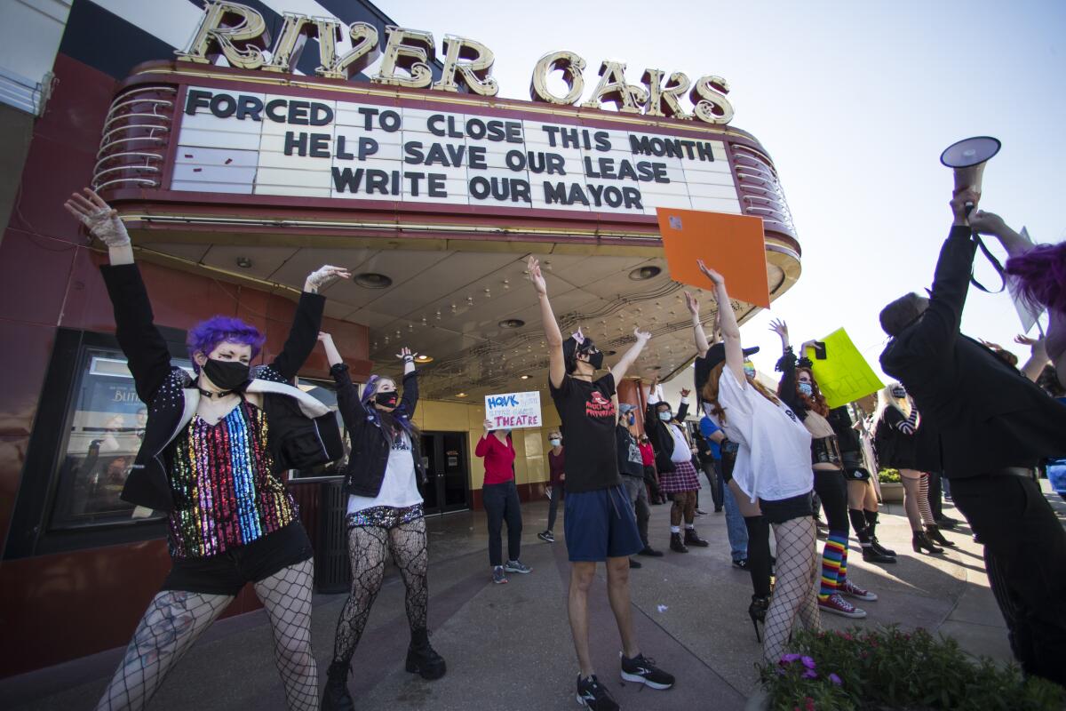 Fans and patrons of the Landmark River Oaks Theatre do the "Time Warp", from the "Rocky Horror Picture Show" as they demonstrate against the potential closure of the historic movie theater Sunday, March 7, 2021, in Houston. The historic Houston theater that director Richard Linklater called his “film school” and that for decades was the place to catch hard-to-find independent and foreign films has closed for good. Like many U.S. movie theaters and other businesses, the River Oaks Theatre was a victim of the coronavirus pandemic.. ( Brett Coomer/Houston Chronicle via AP)