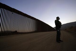 Border Patrol agent Justin Castrejon speaks in front of newly replaced border wall sections Thursday, Sept. 24, 2020, near Tecate, Calif. Top Trump administration officials will visit South Texas five days before Election Day to announce they have completed 400 miles of U.S.-Mexico border wall, attempting to show progress on perhaps the president's best-known campaign promise four years ago. But most of the wall went up in areas that already had smaller barriers. (AP Photo/Gregory Bull)