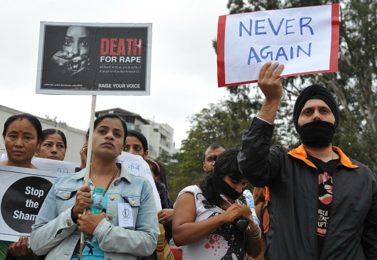 Indian protesters hold a demonstration in Bangalore in December after the death of a woman who was gang-raped in New Delhi.