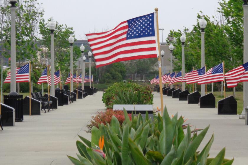 Flags fly over a portion of the 52 Boats Memorial at NTC Park at Liberty Station in Point Loma.