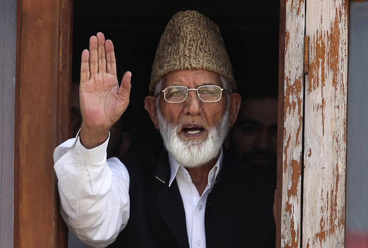 FILE - In this Wednesday, Sept. 8, 2010, file photo, Kashmiri separatist leader Syed Ali Shah Geelani waves to the media before his arrest in Srinagar, India. Geelani, an icon of disputed Kashmir’s resistance against Indian rule and a top separatist leader who became the emblem of the region’s defiance against New Delhi, died late Wednesday, Sept, 1, 2021. He was 92. (AP Photo/Altaf Qadri, File)