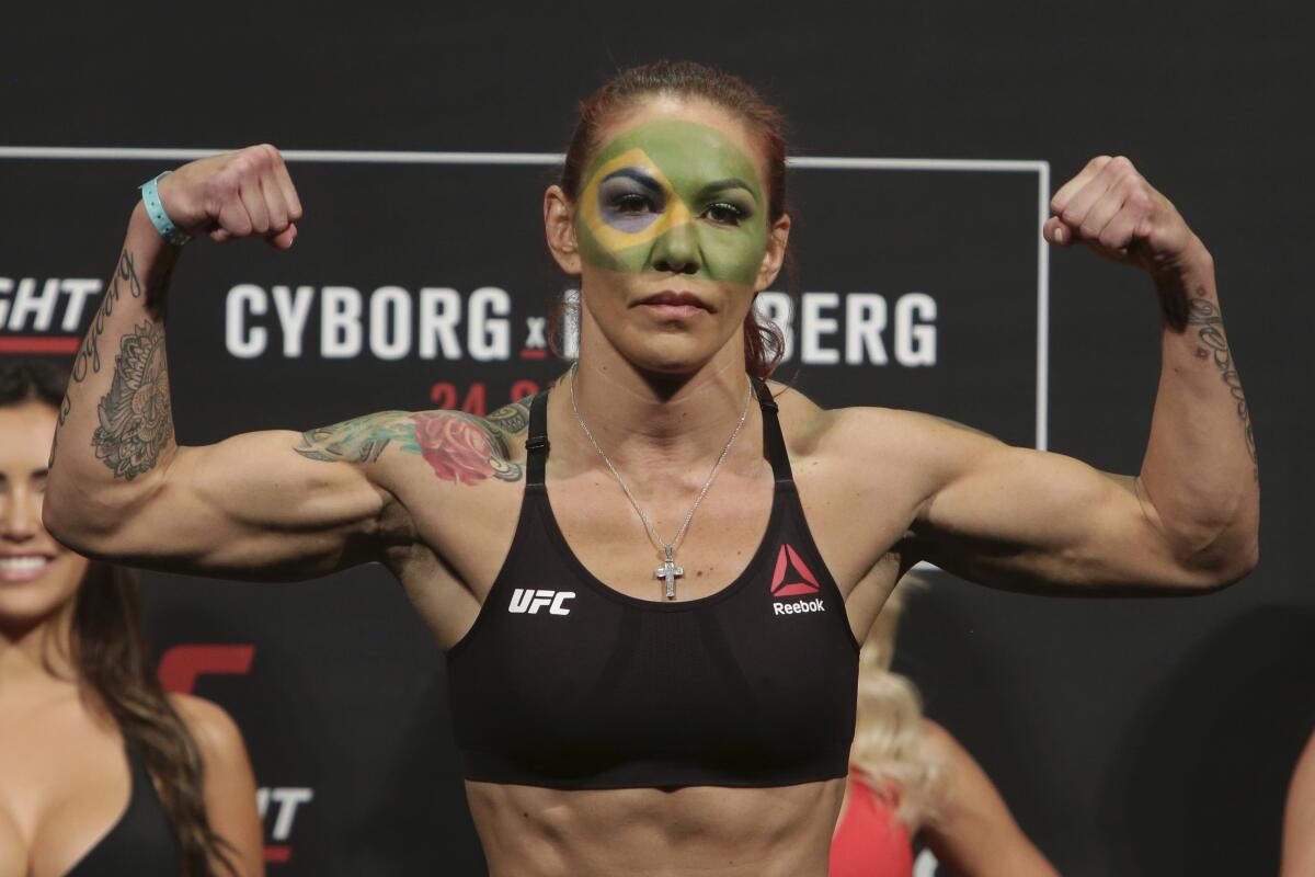 FILE - In this Sept. 23, 2016, file photo, Brazil's Cristiane Justino, known as "Cris Cyborg," poses during the weigh-in for her UFC Fight Night in Brasilia, Brazil. The U.S. Anti-Doping Agency has cleared UFC featherweight Justino on Friday, Feb. 17, 2017, of a potential policy violation, ending her suspension. (AP Photo/Eraldo Peres, File)