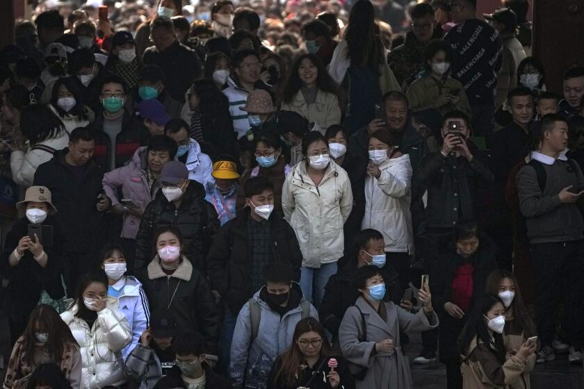 People, some wearing face masks visit the Temple of Heaven park in Beijing, Sunday, Feb. 26, 2023. Visitors flock to the tourist sites in cities in China after authorities lifted all bans on public gatherings from the outbreak of COVID-19. (AP Photo/Andy Wong)