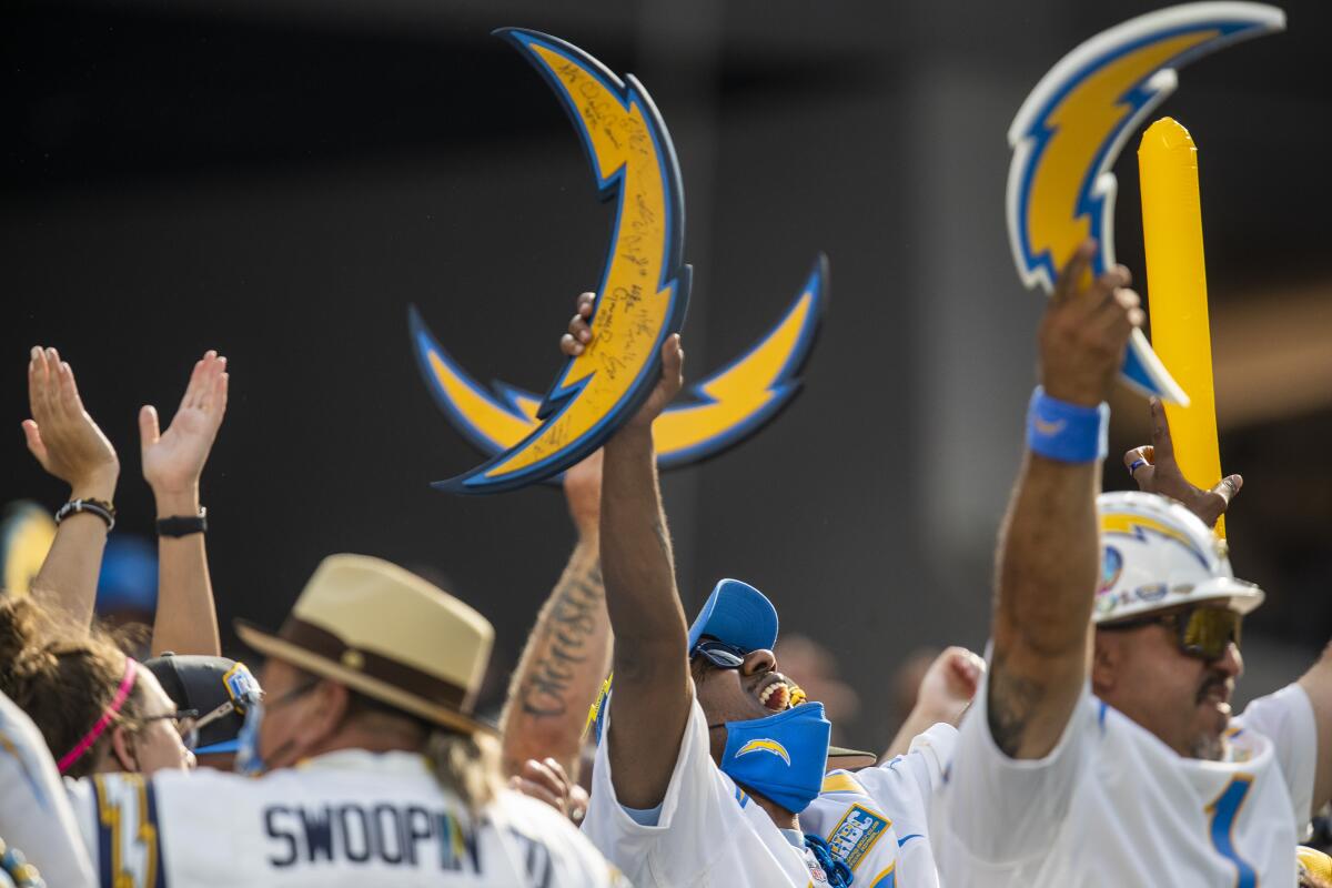 Chargers fans cheer during a tied game in the fourth quarter against the Dallas Cowboys at SoFi Stadium.