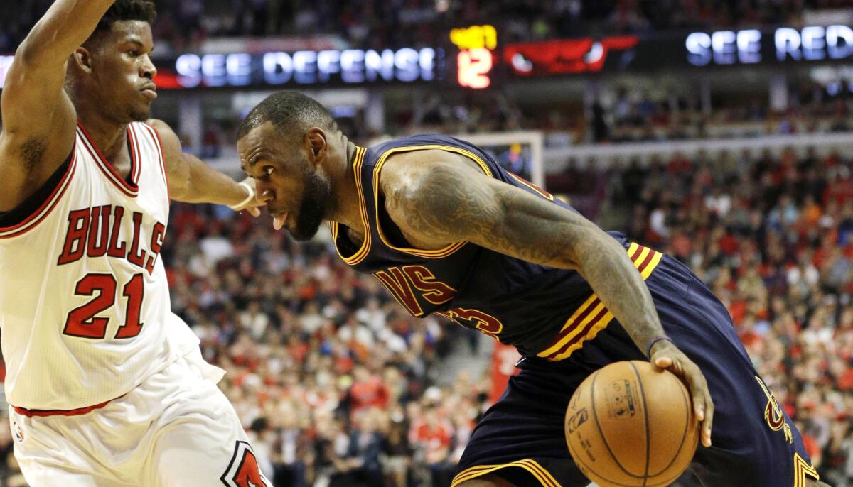 Cavaliers forward LeBron James drives to the basket against Bulls guard Jimmy Butler in the first half of Game 6 on Thursday night in Chicago.