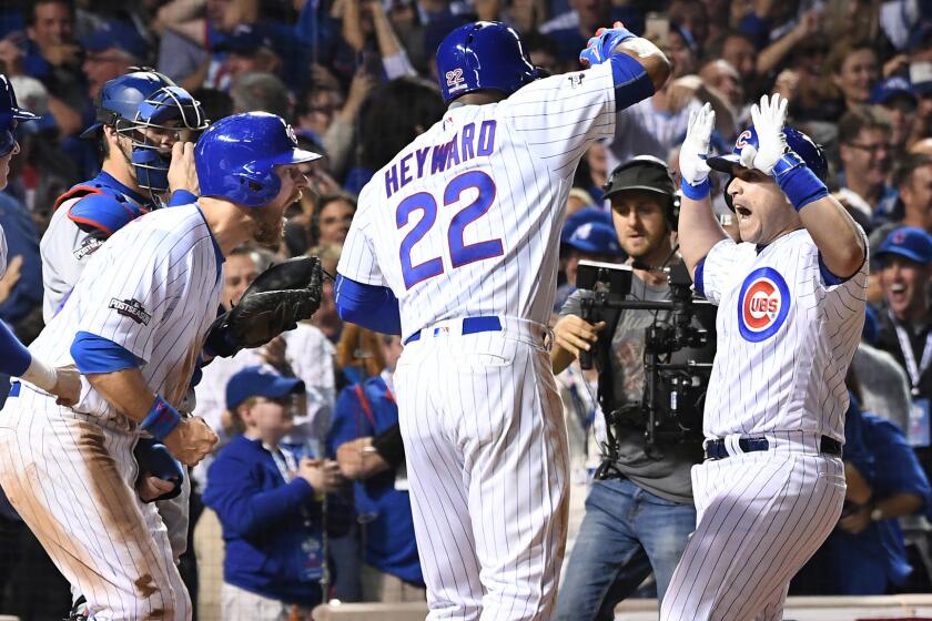Cubs pinch-hitter Miguel Montero, right, is greeted by teammates after hitting a tiebreaking grand slam homer against the Dodgers in the eighth inning of Game 1.