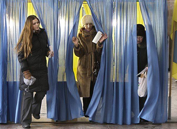 Voters exit booths at a polling station in Dnipropetrovsk after casting ballots in the Ukrainian presidential runoff. Conservative Viktor Yanukovich faces Prime Minister Yulia Tymoshenko in the race. Full report