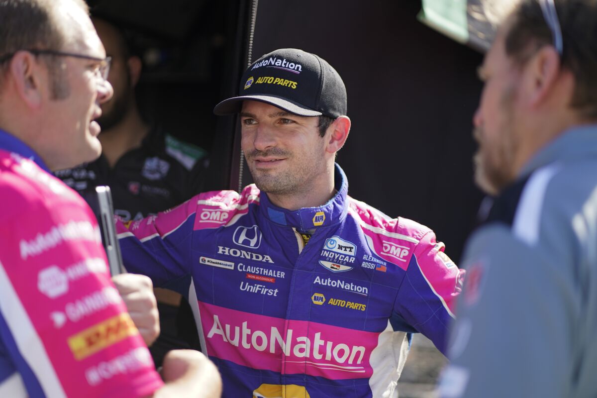 Alexander Rossi talks with his car following practice for the IndyCar auto race at Indianapolis Motor Speedway, Friday, May 13, 2022, in Indianapolis. (AP Photo/Darron Cummings)