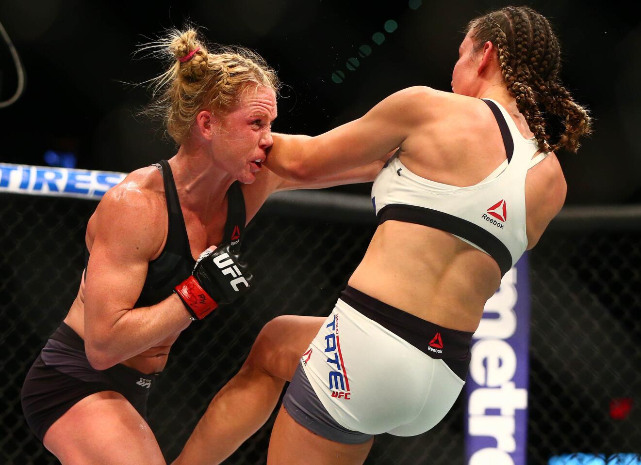 Holly Holm moves in with a punch against Miesha Tate during UFC 196 at MGM Grand Garden Arena.