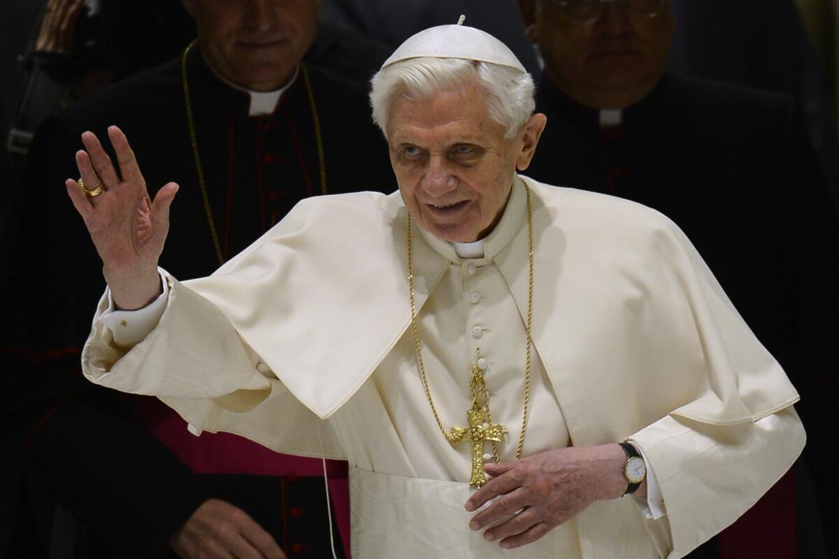 Pope Benedict XVI waves as he arrives for his weekly general audience at the Vatican.