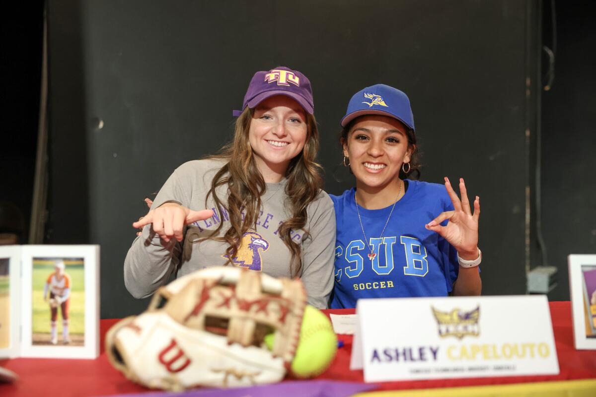 Ocean View's Ashley Capelouto, left, and Isis Salazar pose for a picture during a signing day ceremony on May 15.