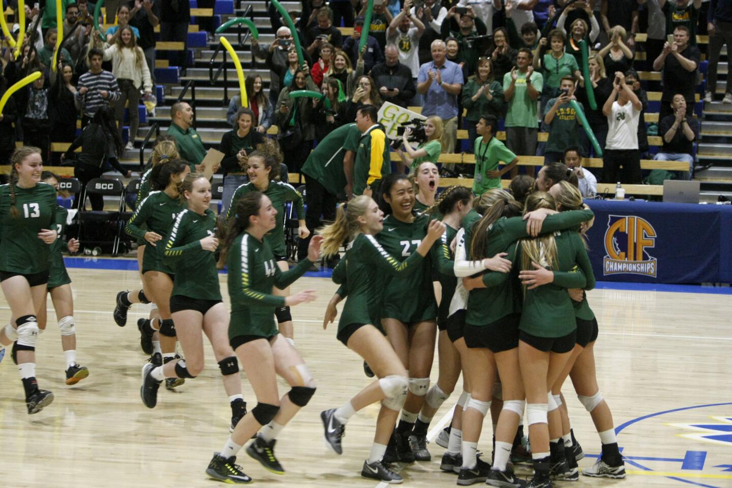 Edison High School volleyball team celebrates the CIF State Division 1 championship win over Menlo Atherton at Santiago Canyon College in Orange, on Friday, Dec. 2, 2016.
