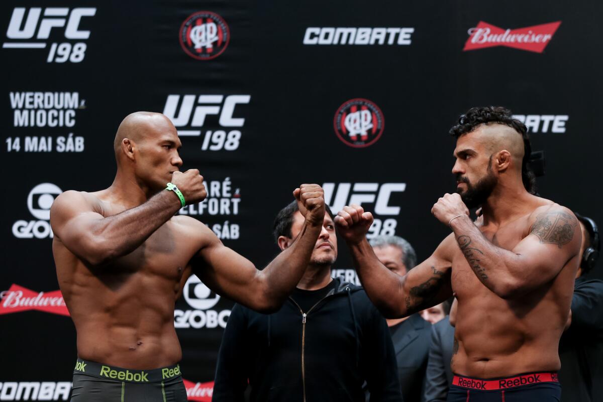 Ronaldo Jacare Souza, left, and Vitor Belfort face off during the UFC 198 weigh-in in Curitiba, Brazil.