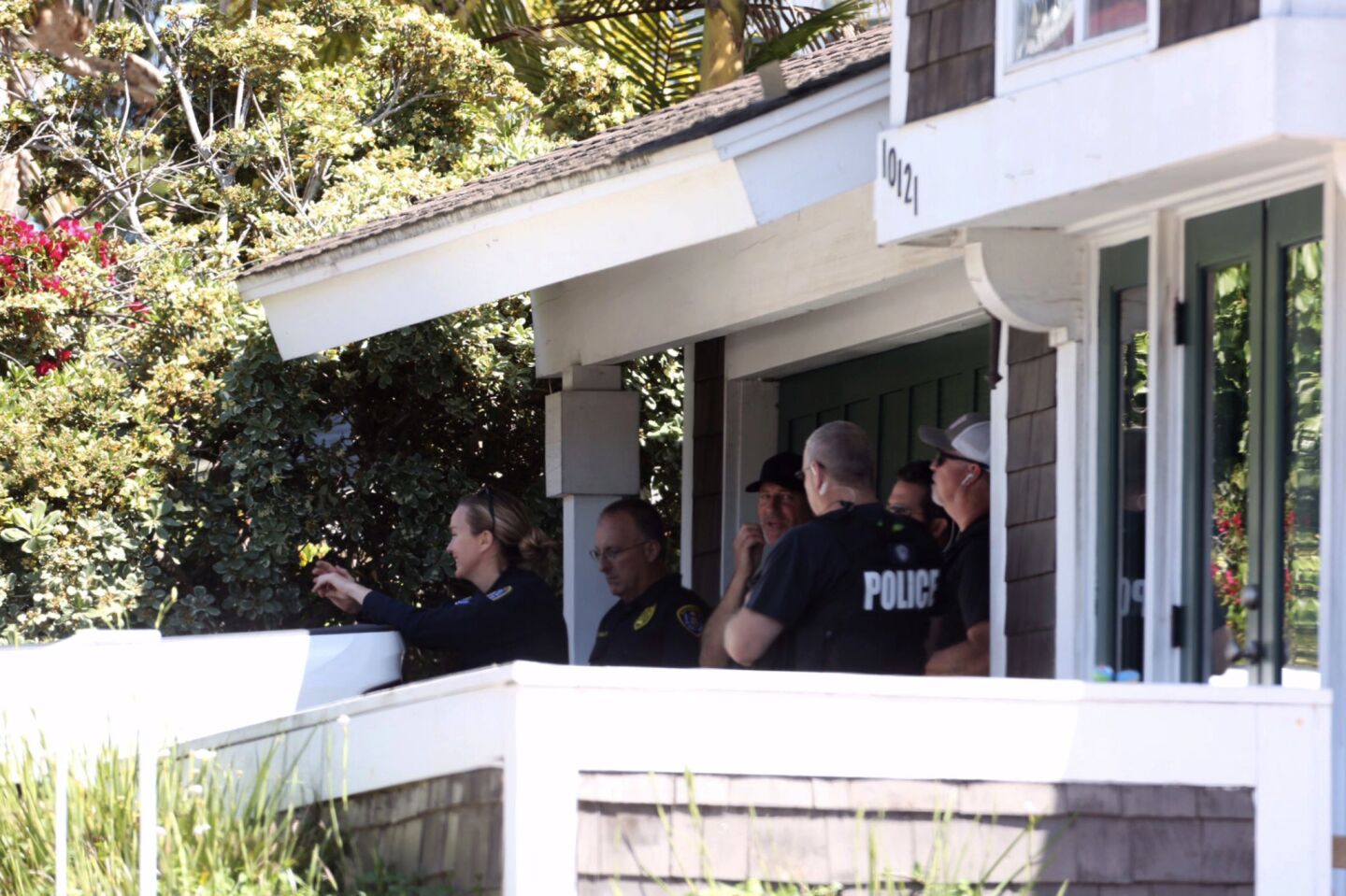 Police surround a house related to the investigation of the synagogue shooting in Poway.
